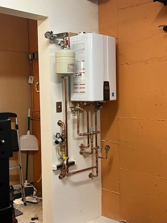 Plumbing technician inspecting water heater connections in Mentor-on-the-Lake